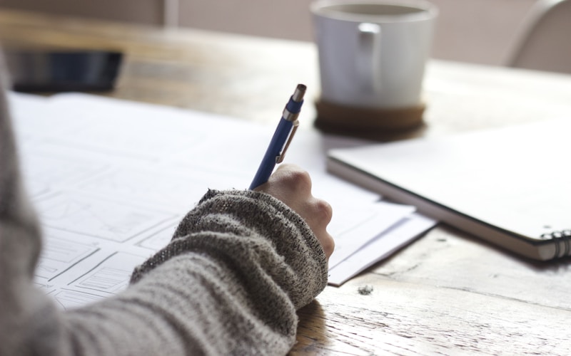 Coffee cup and notebook on a counter